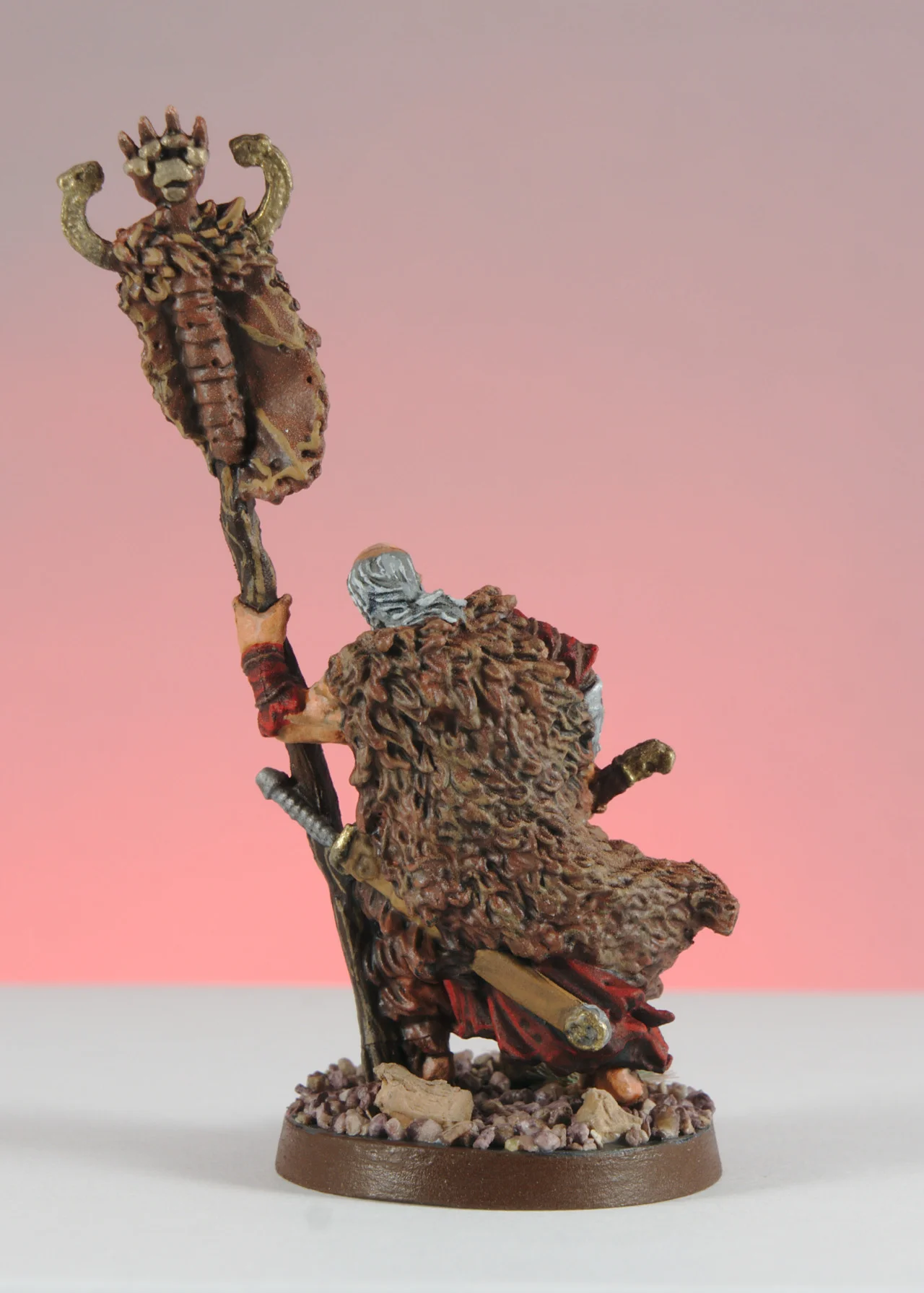 Rear view of the Bear Clan leader showing the textured fur cloak, shield, and snowy base.