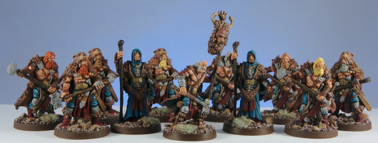 The completed Blood Rage Bear Clan assembled against a blue background, with turquoise clothing and snowy bases.